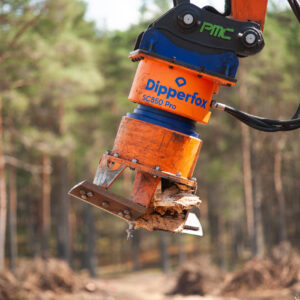 Man Driving Dipperfox Stump Crusher 850 Pro Attached To Skid Steer Outside