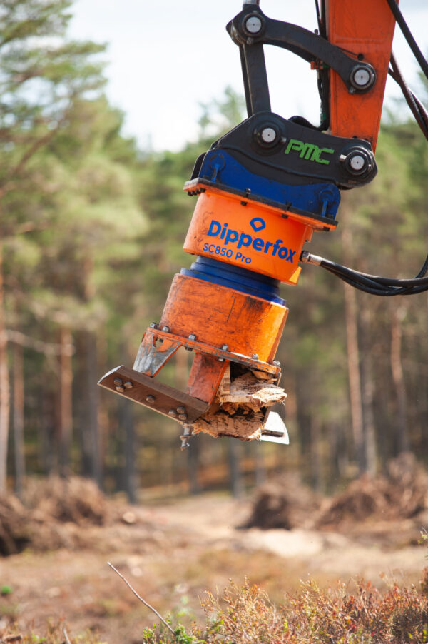 Man Driving Dipperfox Stump Crusher 850 Pro Attached To Skid Steer Outside