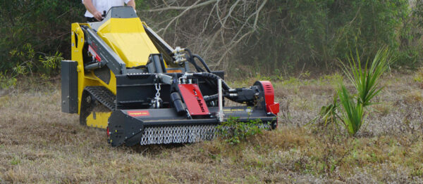 SMWA skid steer outside clearing vegetation