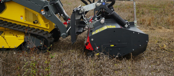 SMWA skid steer clearing land