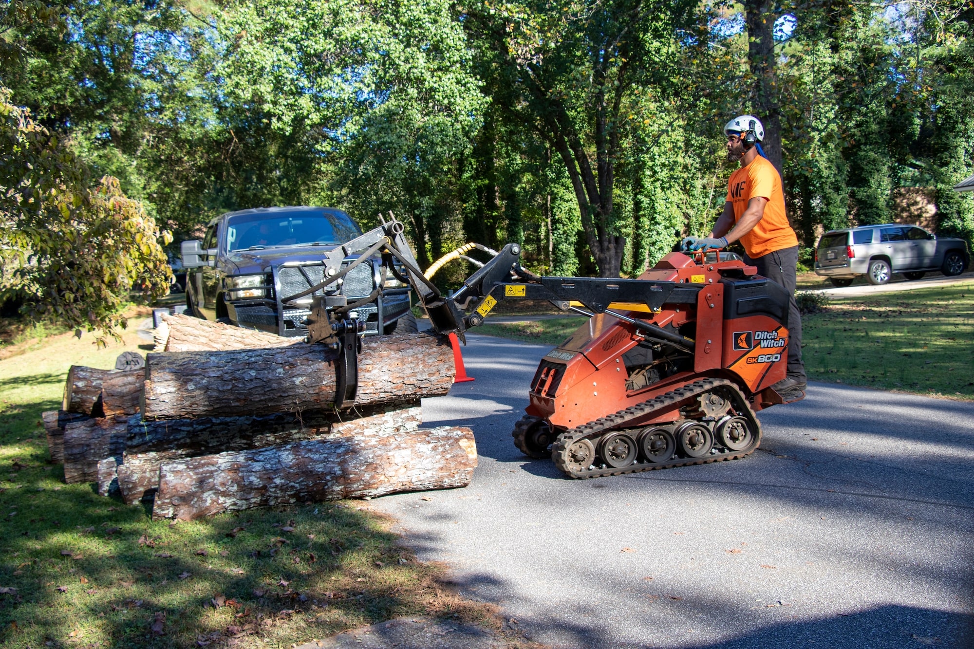 Man using DitchWitch machine to cut trees