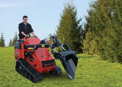 Man Operating Erskine Skid Steer Attachments Mini Spade Outside